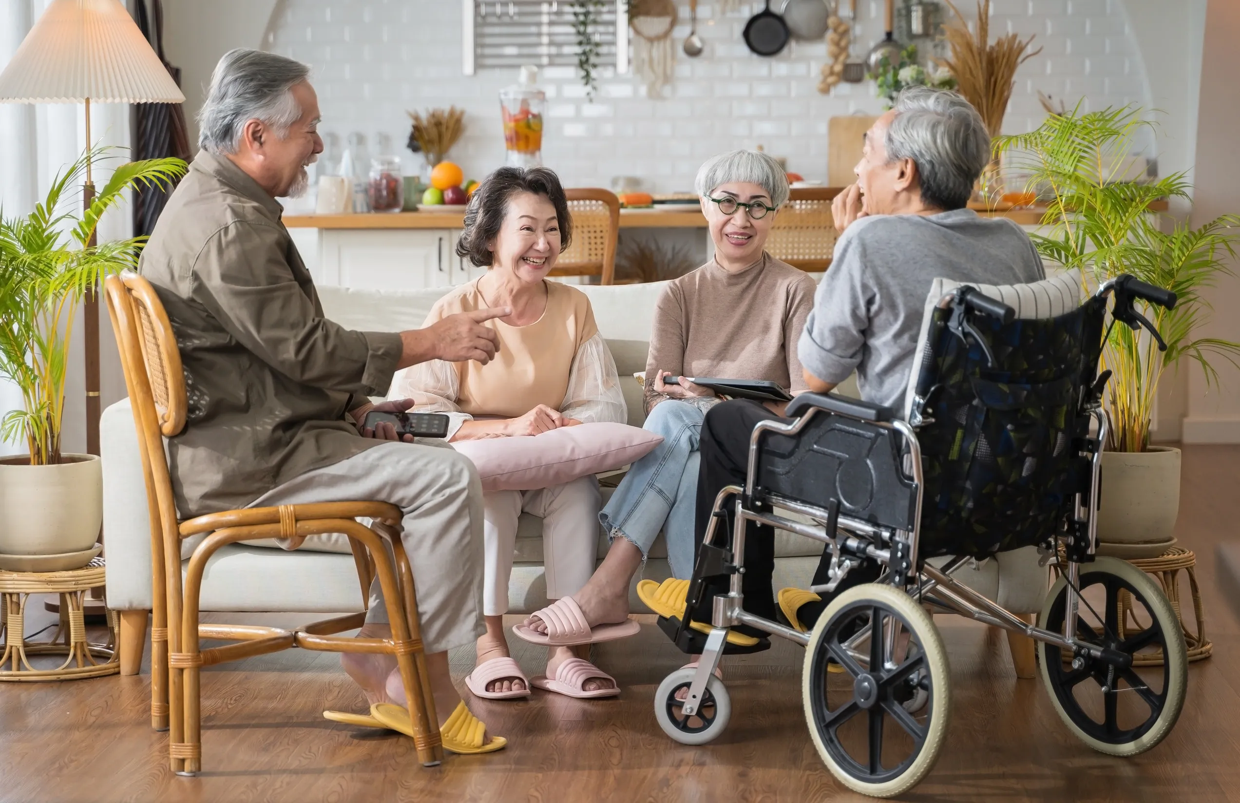 Group Asian seniors friends are sitting in the living room of a home together, enjoying talking together. Group Asian seniors friends are sitting in the living room of a home together, enjoying talking together